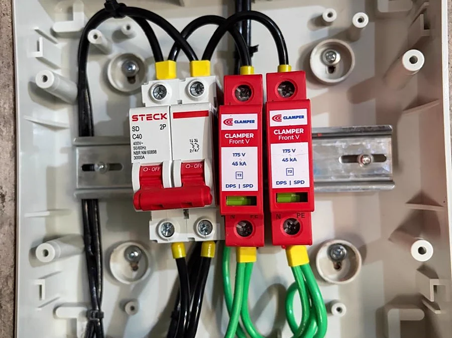 Dispositivos de proteção contra surto e aterramento instalados no quadro.