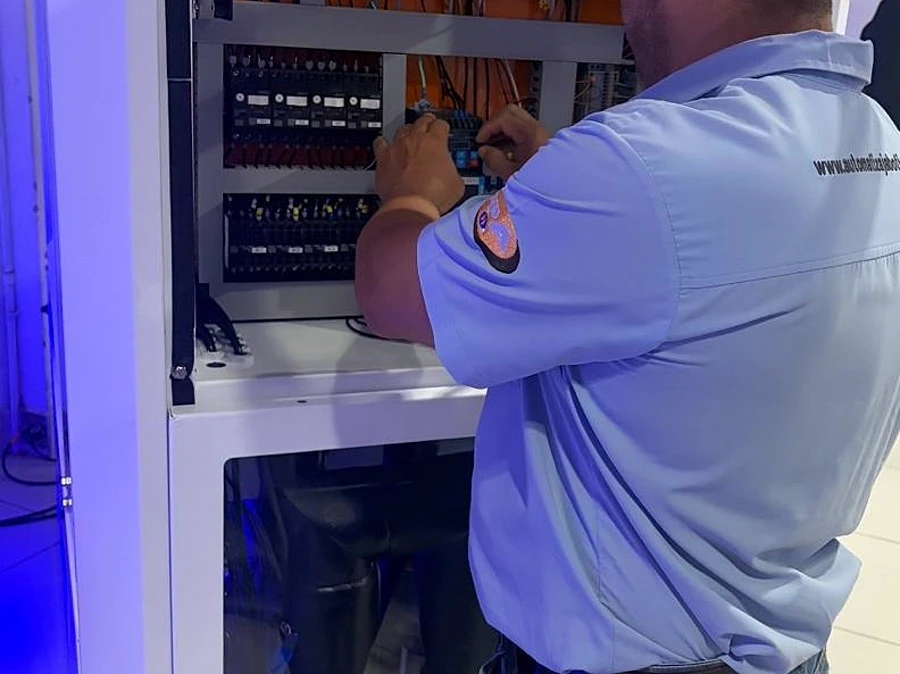 Eletricista da Automatiza trabalhando dentro do quadro elétrico durante instalação em Campinas.